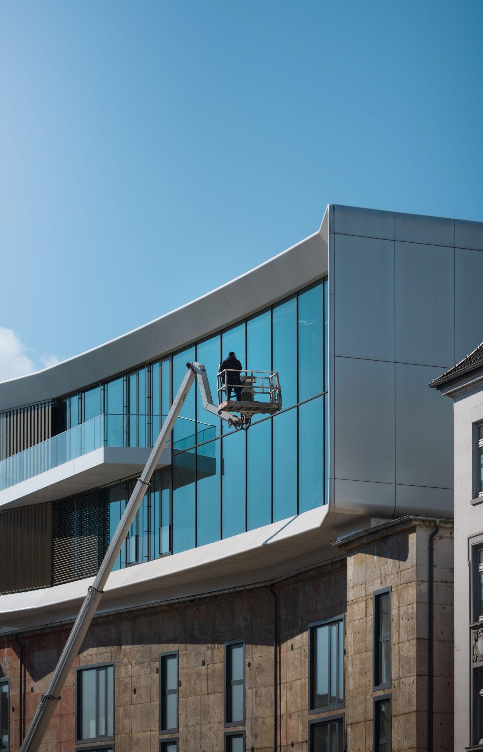 Cladding panels cleaned by access platform on a modern building